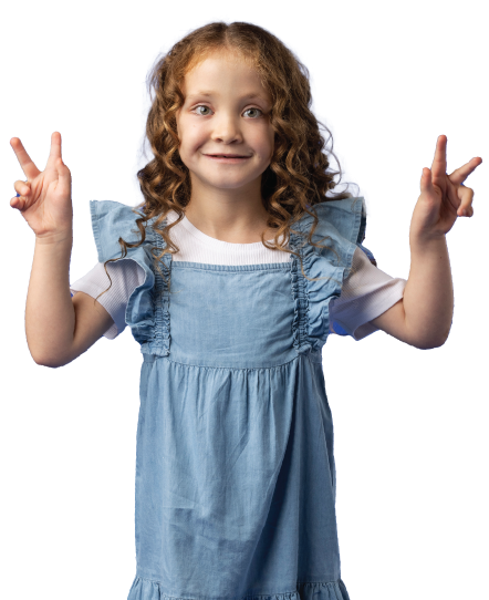 A child with curly hair wearing a blue dress over a white shirt, holding up both hands in a peace sign. A child with curly hair wearing a blue dress over a white shirt, holding up both hands in a peace sign.